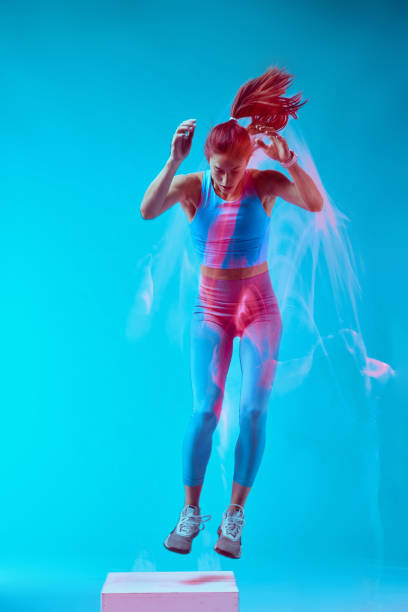 istock A sportswoman doing box jumps and exercising. Long exposure capture movement. 1457114608