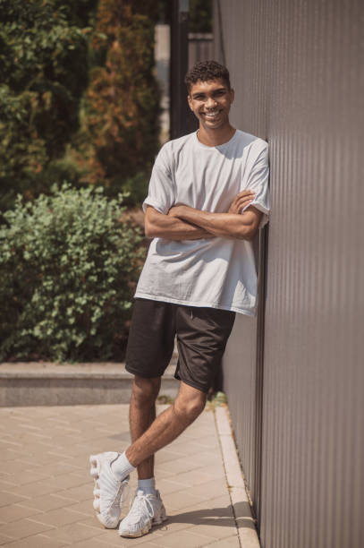 istock Pleased African American guy standing alone outside 1457115117