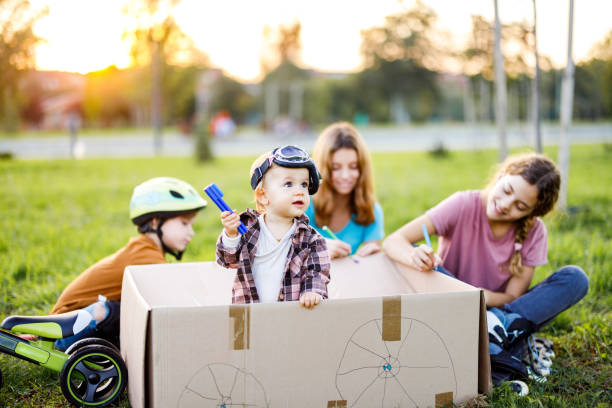 istock Children playing whit cardboard box in the nature 1457116327