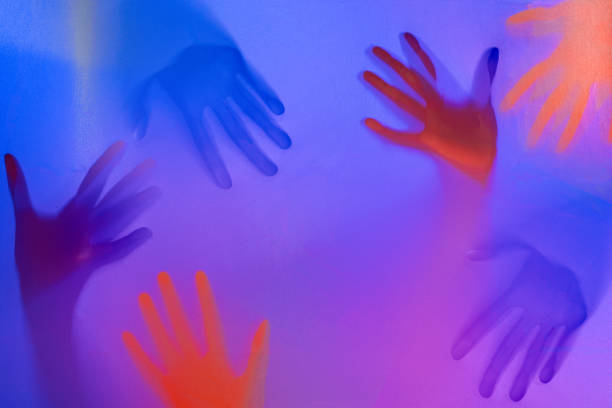 People hands behind frosted glass