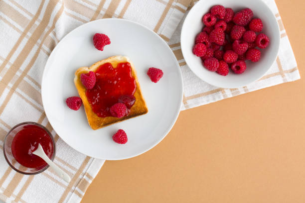 istock Cup of red tea and toasted bread with raspberry jam 1457120776