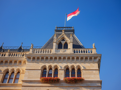 Scenic view of Viena capital, impressive gothic architecture of City hall or Rathaus . Travel and landmarks of Austria, details and flowers and flag of Vienna on buildings