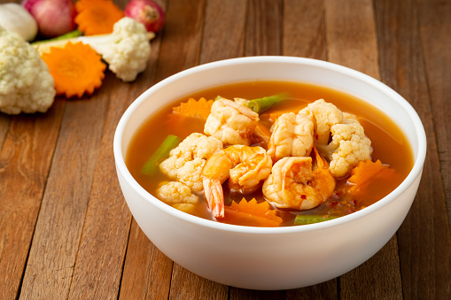 hot and spicy soup with mixed vegetable and Shrimp in white bowl.Thai traditional healthy menu and diet food.
