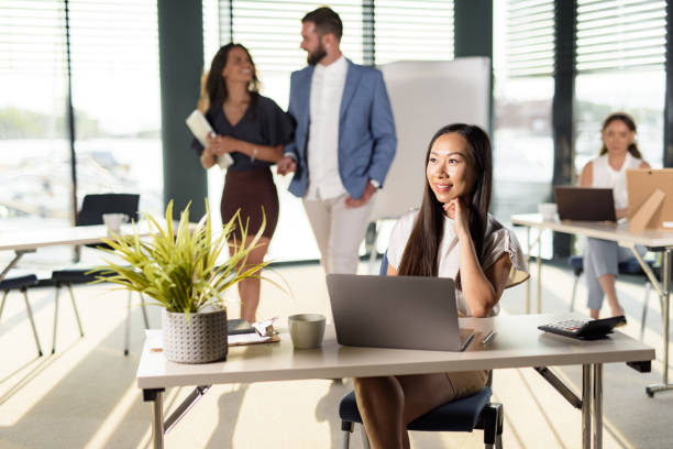 istock Young businesswoman looking away while working in the office 1457124896