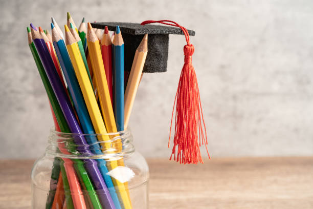istock Pencils with graduation hat in glass, education learning concept. 1457125014