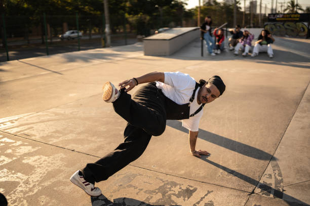istock Mid adult man breakdancing at skateboard park 1457125051