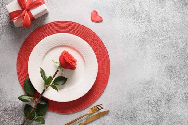 istock Valentine's day dinner with romantic gift and red roses. 1457127228