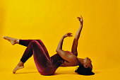 Contemporary dancer in energetic pose on the studio floor.