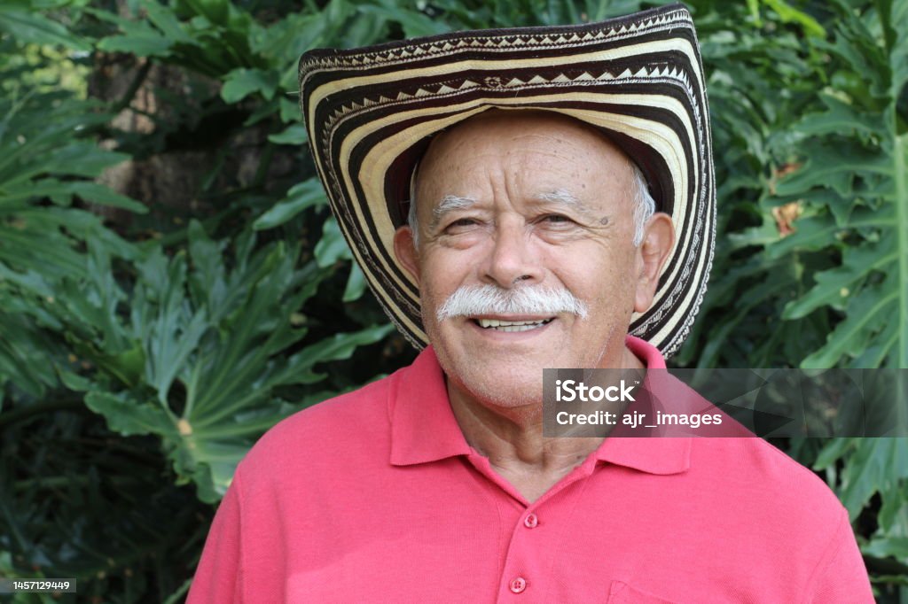 Senior man wearing traditional Colombian hat A senior man in his sixties is wearing a traditional Colombian hat. He has white hair and wears a mustache. Colombian Culture Stock Photo