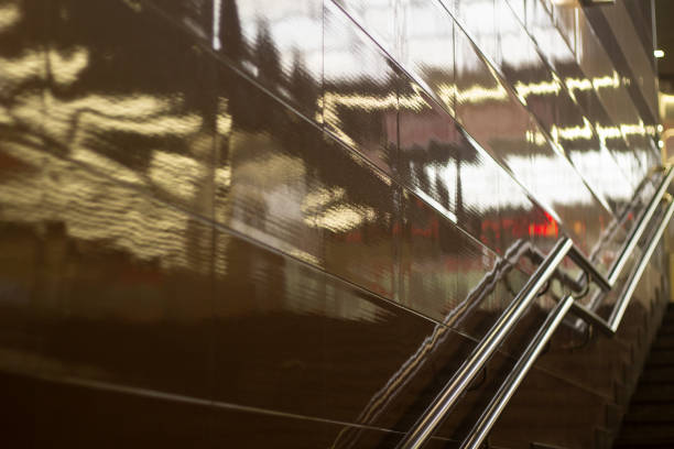 Reflection in wall of light. Handrail for climbing stairs. Architecture details.