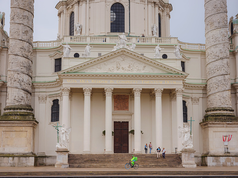 Vienna, Austria - August 8, 2022: Catholic church located in southern part of Karlsplatz, Vienna. One of symbols of city. The Karlskirche is prime example of original Austrian Baroque style.