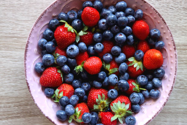 Pink Bowl with Various Berries stock photo