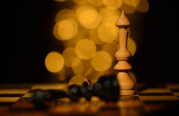 Wood chess pieces on board game. checkmate. the king is defeated stock photo
