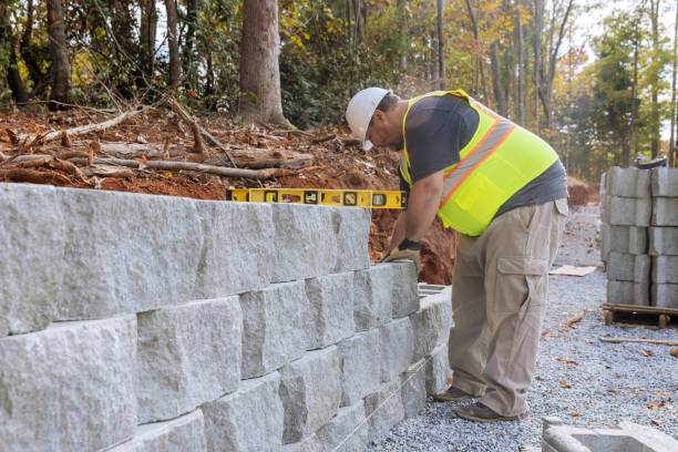 istock Construction worker building a retaining block wall being built on new property 1457138615