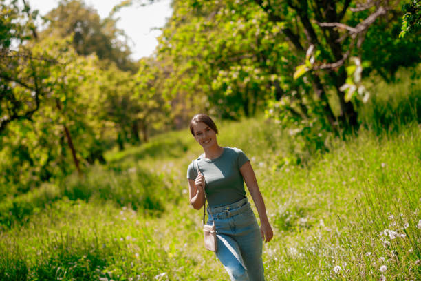 istock Young pretty woman walking in the forest 1457139567