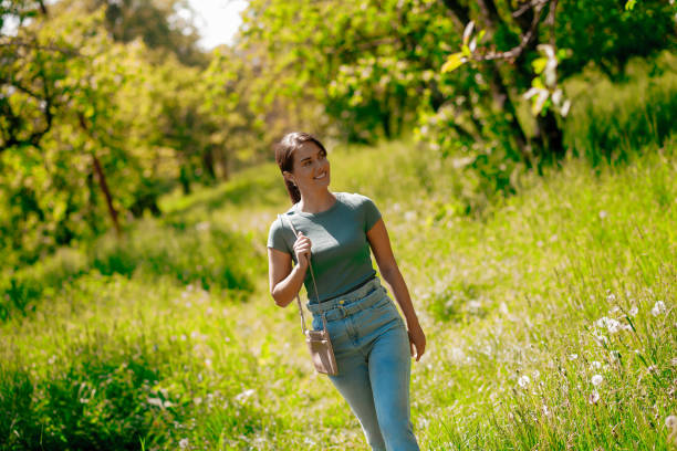 istock Young pretty woman walking in the forest 1457139640