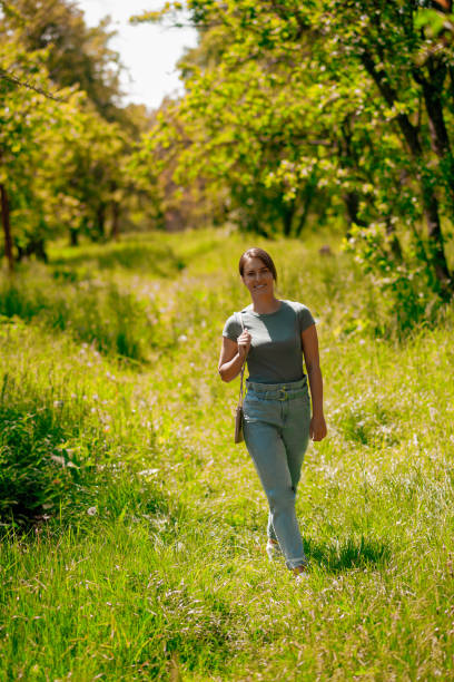 istock Young pretty woman walking in the forest 1457139663