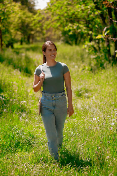 istock Young pretty woman walking in the forest 1457139710