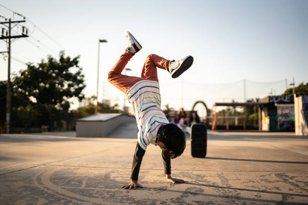istock Child boy breakdancing at skateboard park 1457141517