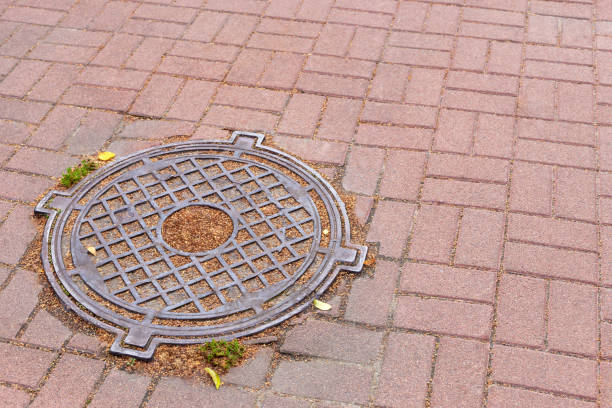 istock Iron sewer manhole on the ground among the tiles 1457142123