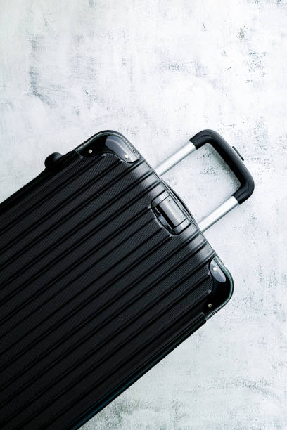 istock Luggage,black suitcase set on a white background top view image flat laying element Minimal travel concept. black and dark classic luggage prototype both small and large luggage accessory set travel concept 1457142149