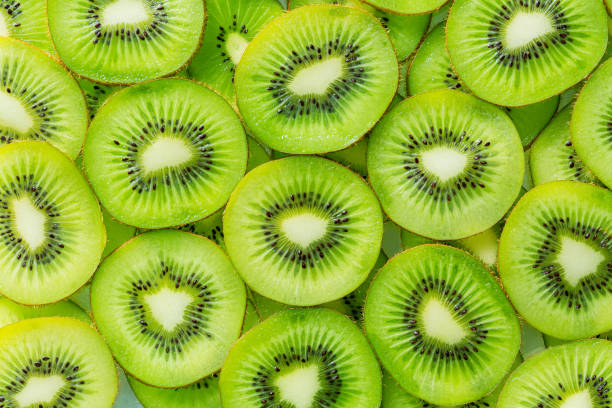 istock macro kiwi,Kiwi fruit pattern. Healthy food background, overhead. 1457142190