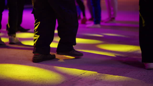 Close-up legs of people dancing on the floor