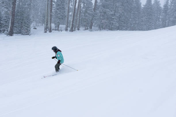 istock Girl skiing under snowy weather 1457145842