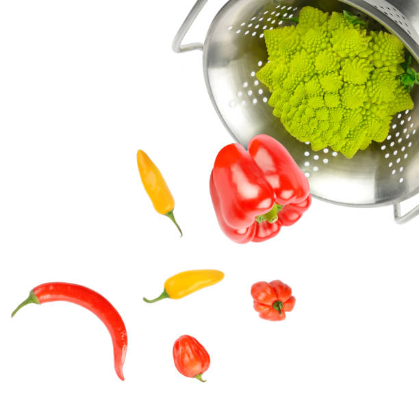 istock Vegetables fall from a colander. Composition isolated on white . Collage. Free space for text. 1457146649