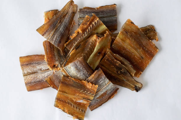 istock Dried fish fillet red cod amber. An snack for beer on a white background. 1457147809