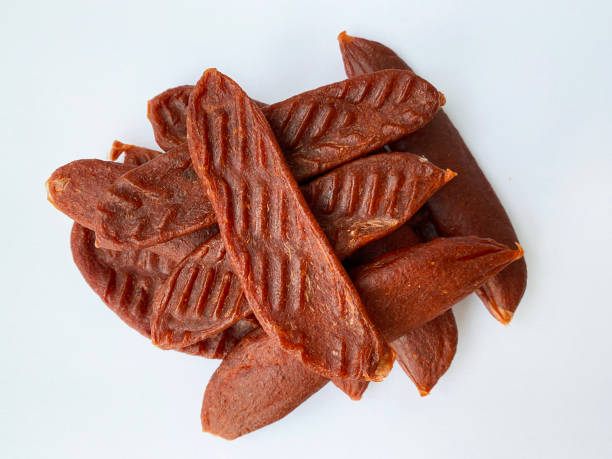 istock Dry salmon or cod roe caviar sticks on white background. Dried fish snacks for beer. 1457147894
