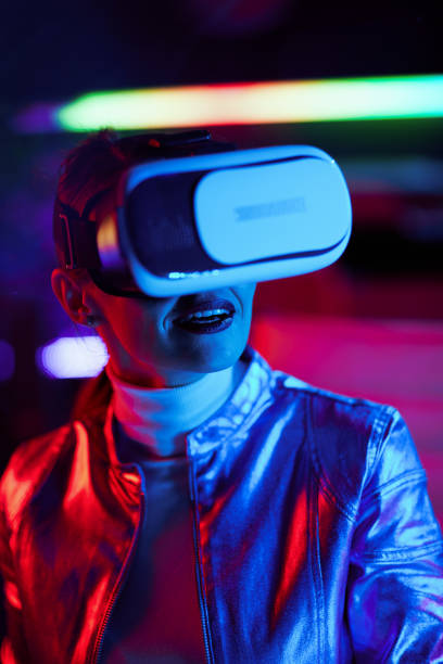 istock smiling stylish woman in vr headset on dark background 1457150953