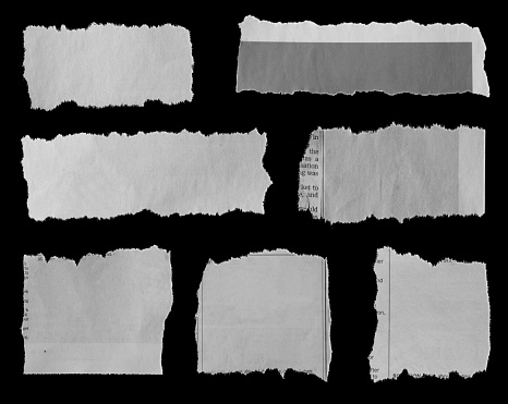 Seven pieces of torn newspaper on black background