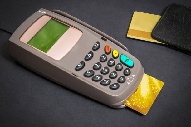 istock Payment terminal with card for receiving money on black background 1457155221