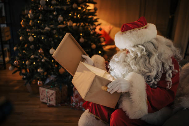 istock Santa Claus opening gift box 1457160485