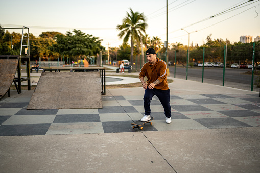 Young man skateboarding at skateboard park