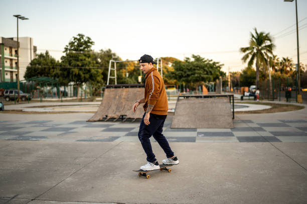 istock Young man skateboarding at skateboard park 1457161082