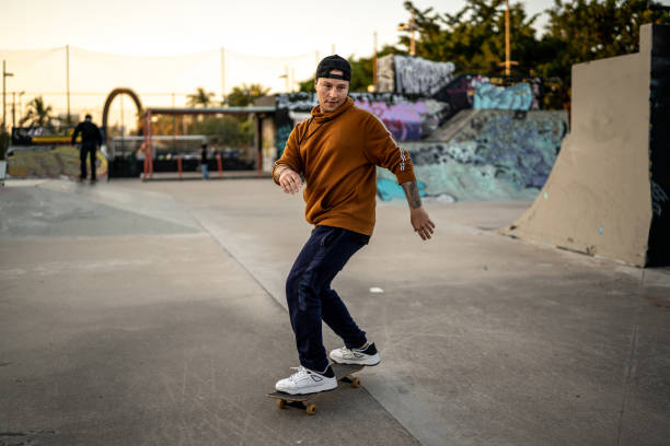 Young man skateboarding at skateboard park