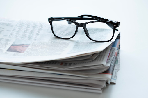 newspaper and eyeglasses