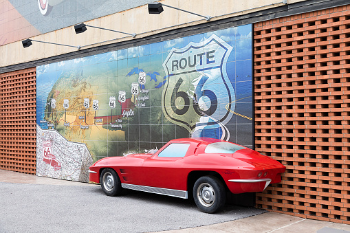 Joplin, USA - May 10, 2019: Famous Route 66 mural with 1/2 car at the Route 66 in historic downtown Joplin, Missouri.