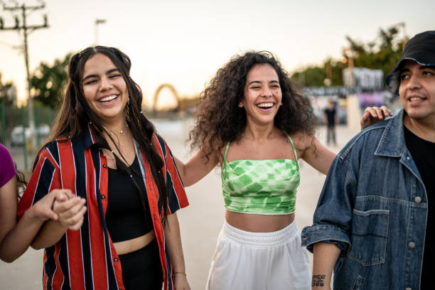 istock Friends having fun while walking at public park 1457164507