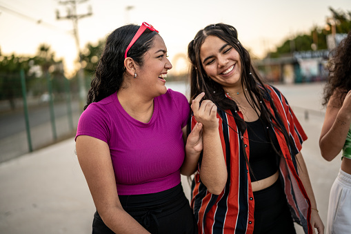 Friends having fun while walking at public park