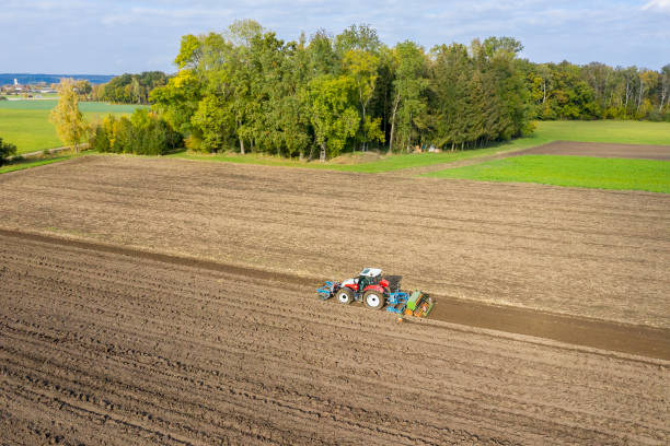 istock Tractor with Harrow on Field, Aerial View 1457171732