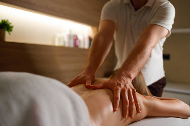 istock Professional masseur making back massage for young woman 1457178786
