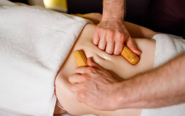 istock Massage of a woman's abdomen with bamboo sticks 1457183016