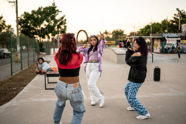 Young women dancing and having fun at skateboard park