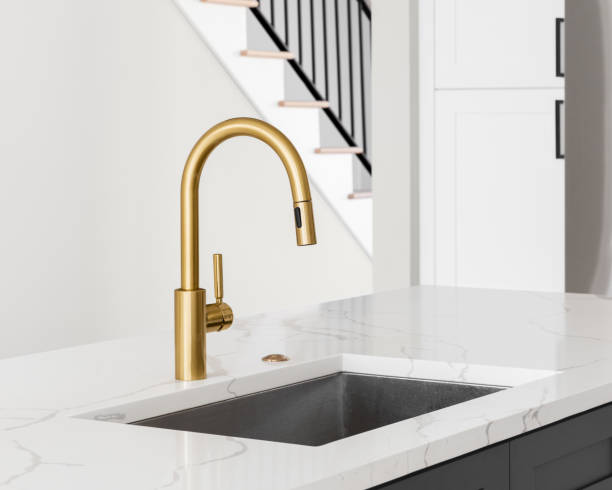 istock A gold faucet in a luxury kitchen. 1457187201