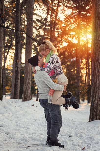 istock A Loving Couple Having Fun in a Winter Forest 1457188595