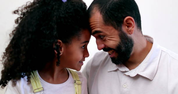 istock Father and child daughter bonding foreheads together 1457190186