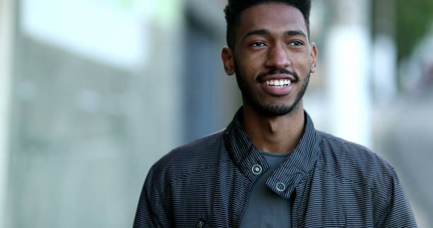 istock Confident black African young man walking outside smiling 1457190357